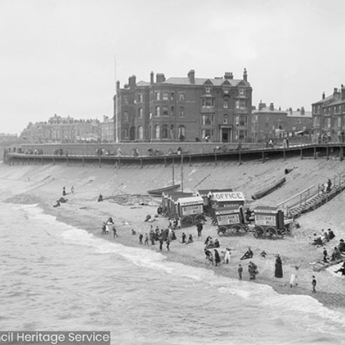 People and bathing machines on the beach