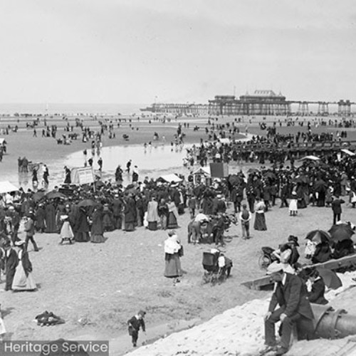 Crowds on beach in front of Blackpool North Pier