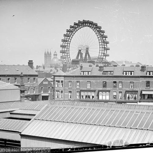 Railway station with Ferris wheel in background