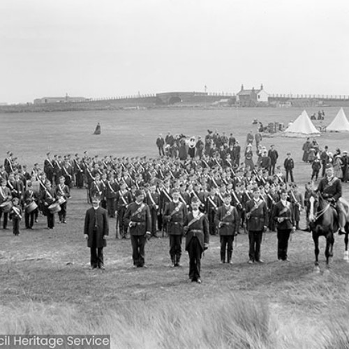 Soldiers standing to attention in field