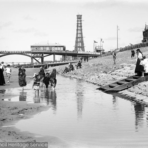 View of Blackpool Tower under construction from the beach