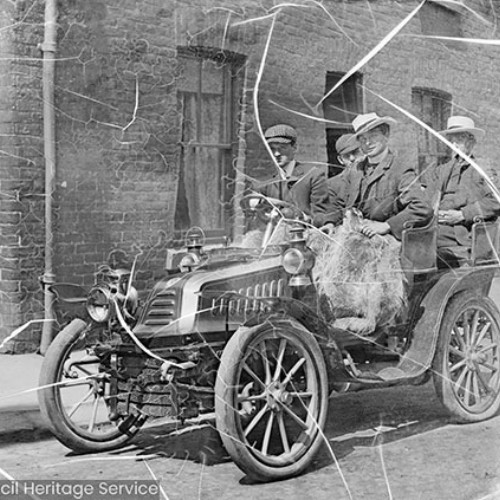 Damaged photograph of people in vintage car