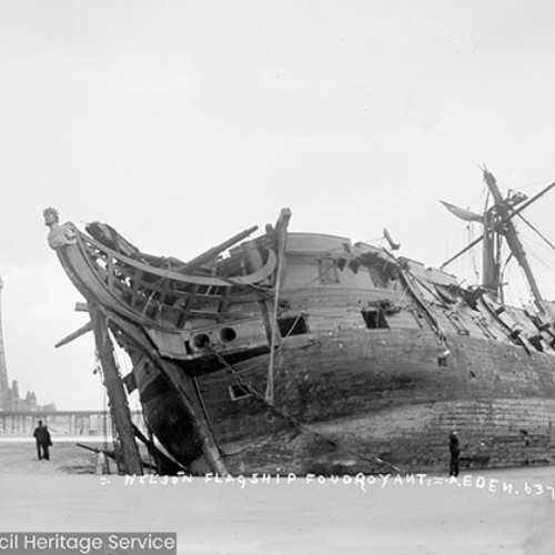 Sailing ship wrecked on beach