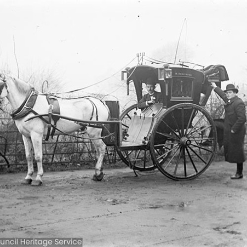 Man standing with horse drawn carriage