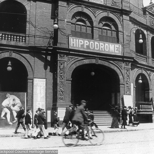 People on street outside of building