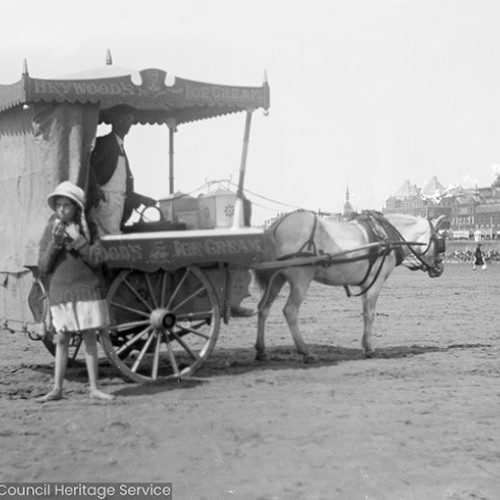 Girl and ice cream cart on the beach