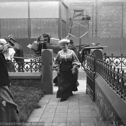 Woman and carriage outside of house