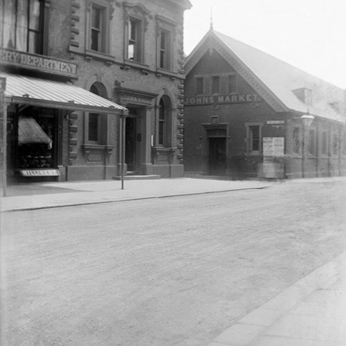 Street scene with buildings including signs for 'Town Hall' and 'John's Market.'