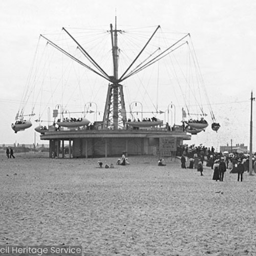 Crowds on a fairground ride on the beach