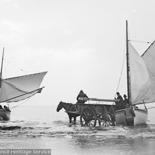 Two sailing boats and a horse and cart on the beach