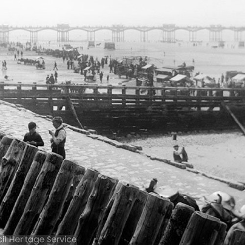 People on the sea defences and beach