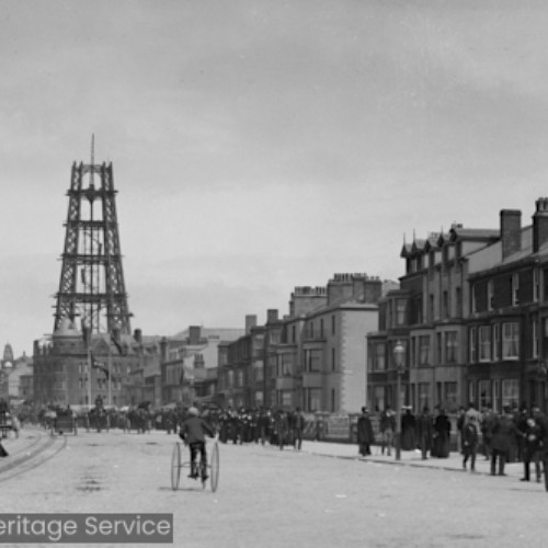 Crowds on Promenade with unfinished Blackpool Tower in background