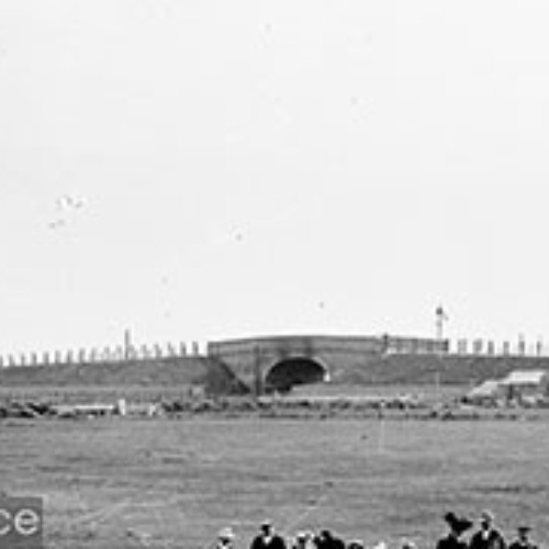 Railway bridge and tents on a campsite