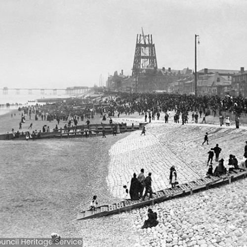 Crowds on beach watching lifeboat