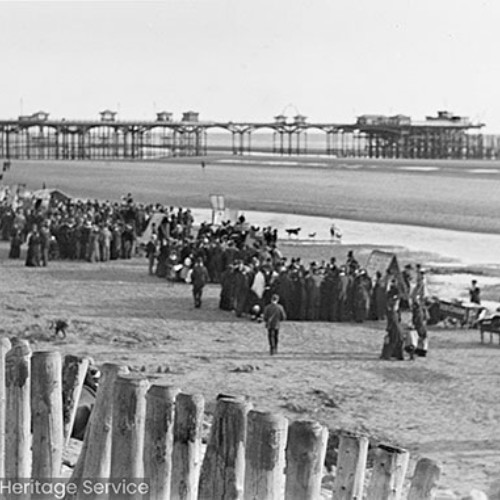 People shopping at stalls on the beach