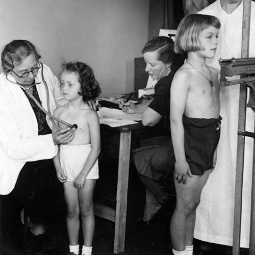 Children being examined by nurses.