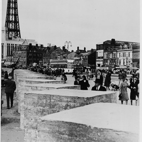 Large concrete blocks in a line on the Promenade, with Blackpool Tower in the background.