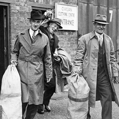 Three men exiting a door, carrying a sack each. Next to the door is a sign which reads Civilian Clothing Centre Entrance.