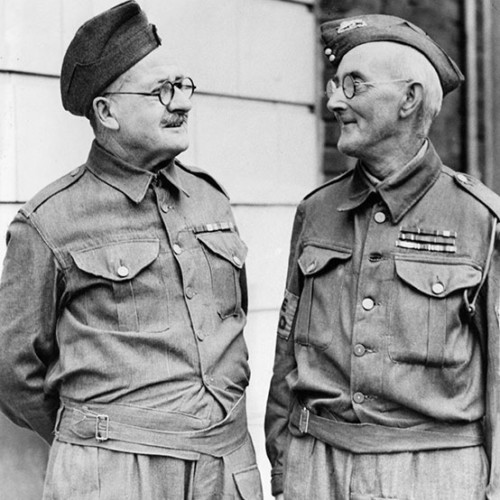 Two members of the Home Guard talking to each other.