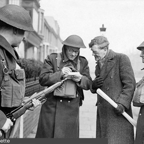 Home Guard questioning a man and taking notes.