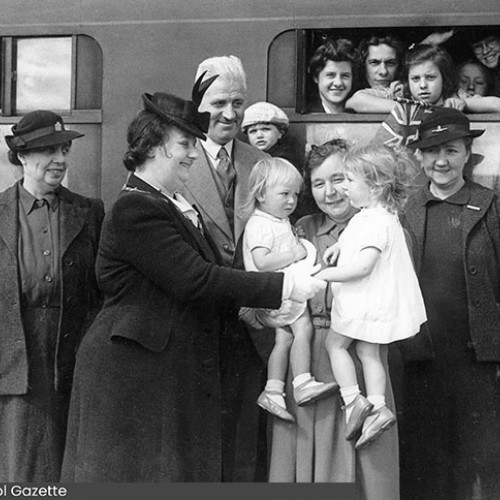 Mayoress greeting a group of children next to the train.