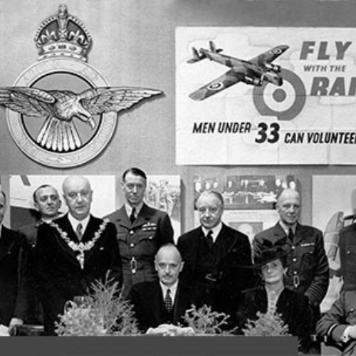 Group of dignitaries including the Mayor in front of RAF posters and signs. Fly with the RAF Men Under 33 Can Volunteer. Never Was So Much Owed By So Many To So Few.