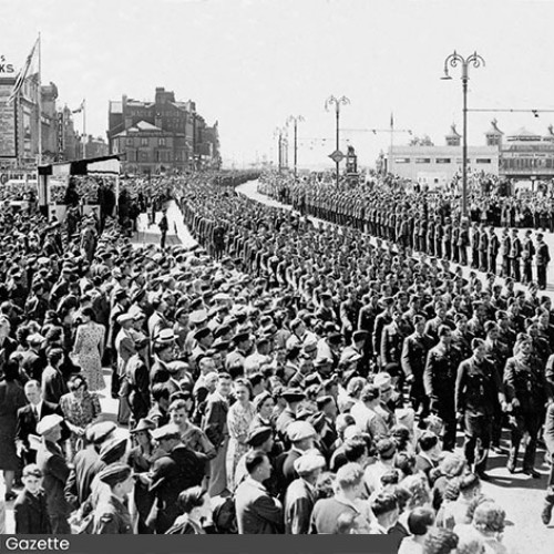 Large number of RAF marching on the Promenade. On either side of the march are spectators.