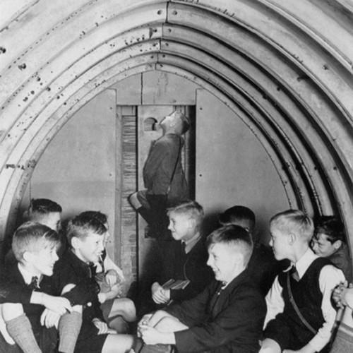 Group of children inside an air raid shelter.