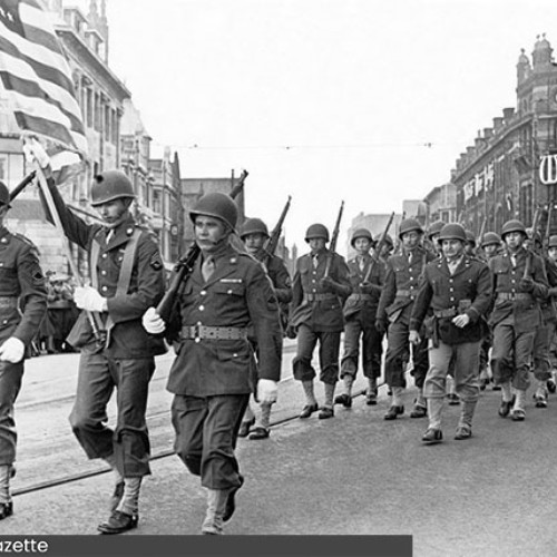 Soldiers marching in front of Yates's Wine Lodge.