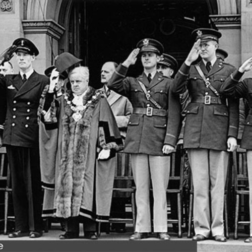 Group of dignitaries and the Mayor stood on the Town Hall steps saluting.