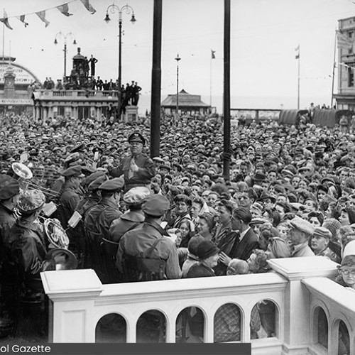 Large crowd watching a band play.