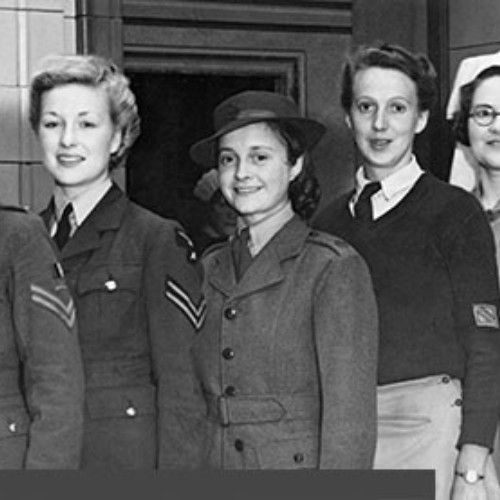 Group of eight women in various uniforms, stood in a line.