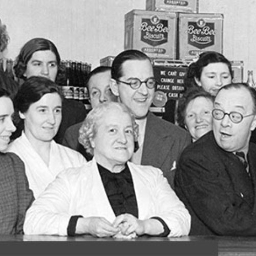 Group of people stood together behind the counter.