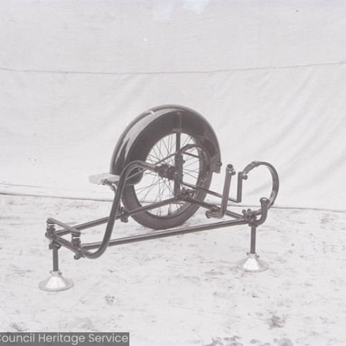 Side view of a motorcycle sidecar wheel mounted on a stand.