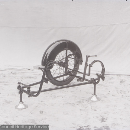Side view of a motorcycle sidecar wheel mounted on a stand.