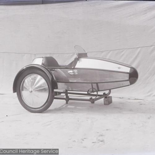 A side view of a motorcycle sidecar.