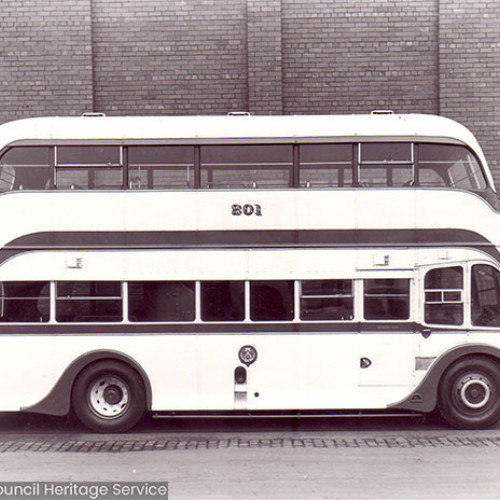 Side view of a double decker bus with number 201 on the side.