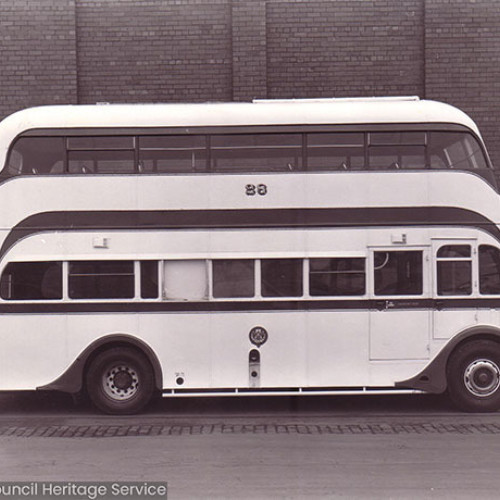 A side view of a double decker bus with the number 28 on the side.