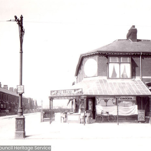 Street scene of a grocers shop with a veranda.