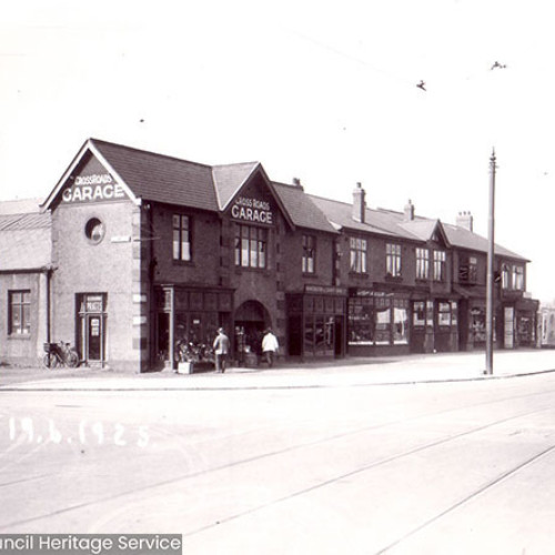 Street scene including garage building.