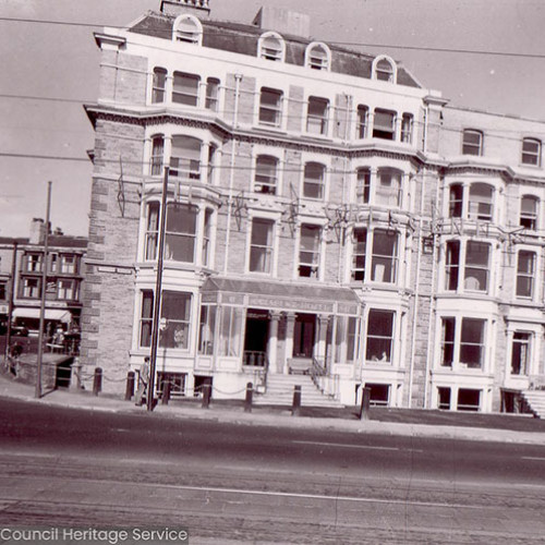 Street scene of a large hotel building.