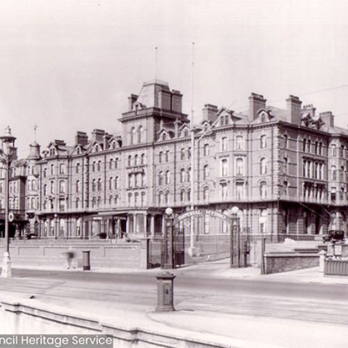 Street scene of a large hotel building.