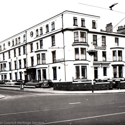 Street scene of a large  hotel building.