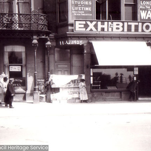 Street scene of people walking on Promenade outside of waxworks.