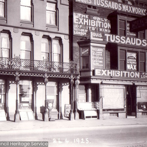 Street scene showing hotel and next door waxworks.