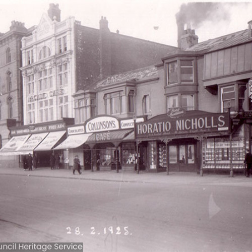 Street scene with parade of shops and restaurants.