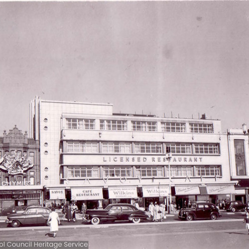 Street scene of shops and restaurants.