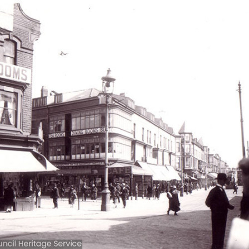 Busy street scene with parades of shops and restaurants.