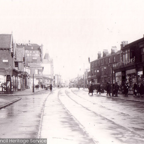 Street scene with pedestrians and shops.