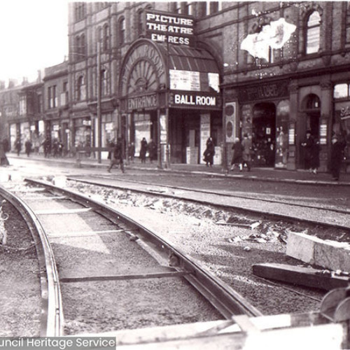 Street scene with tram track under construction in foreground and Winter Gardens in background..